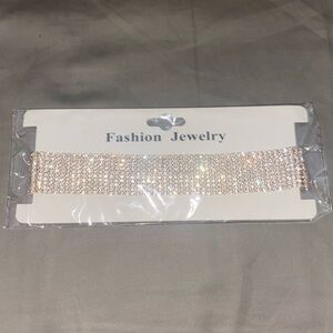 Costume jewelry gold colored rhinestone choker with body chain